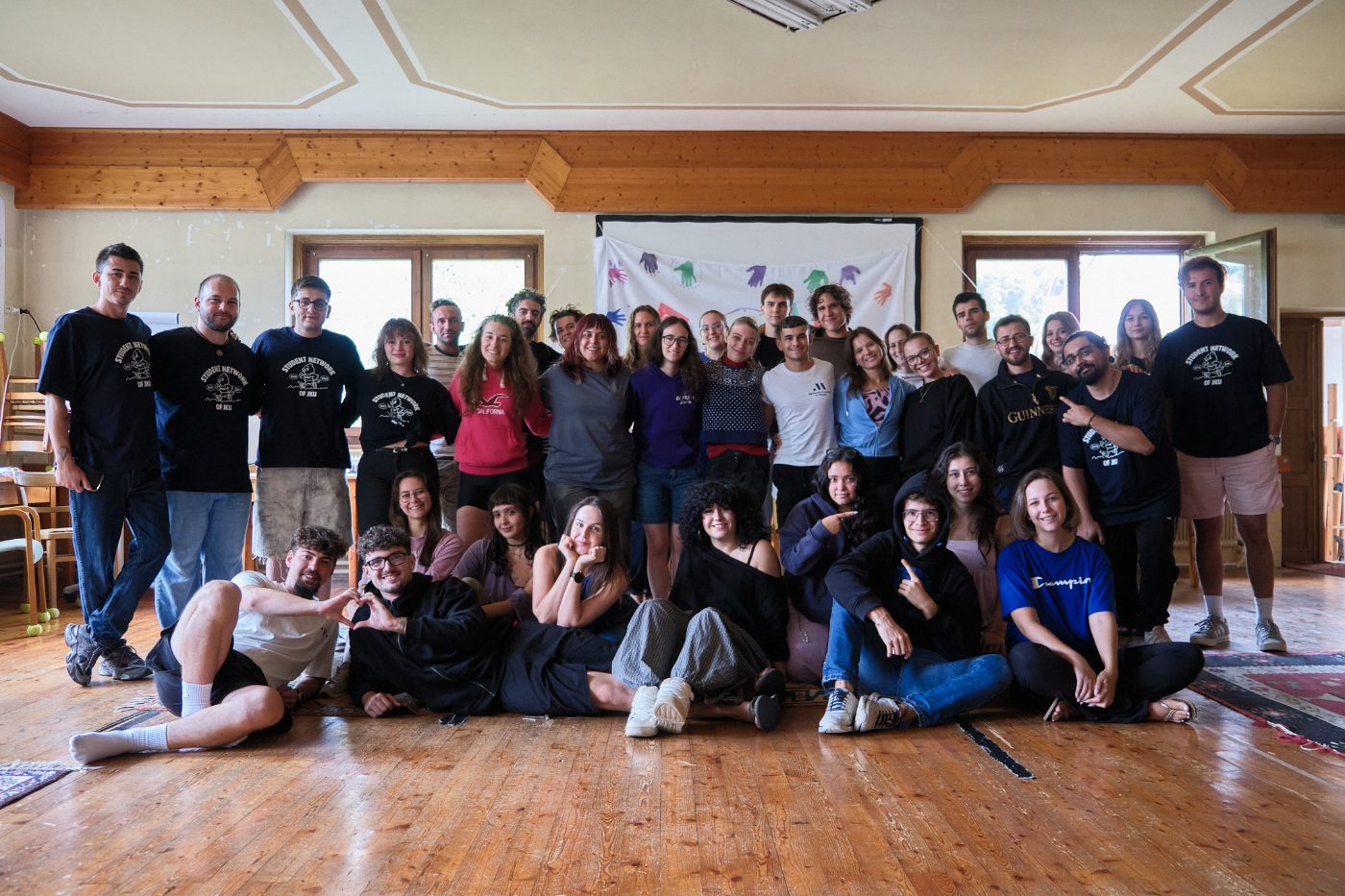 Group photo of the It is OK! participants and team in the seminar room