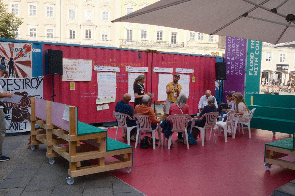 Participants in a discussion circle at the Ars Electronica Festival on Hauptplatz, Linz